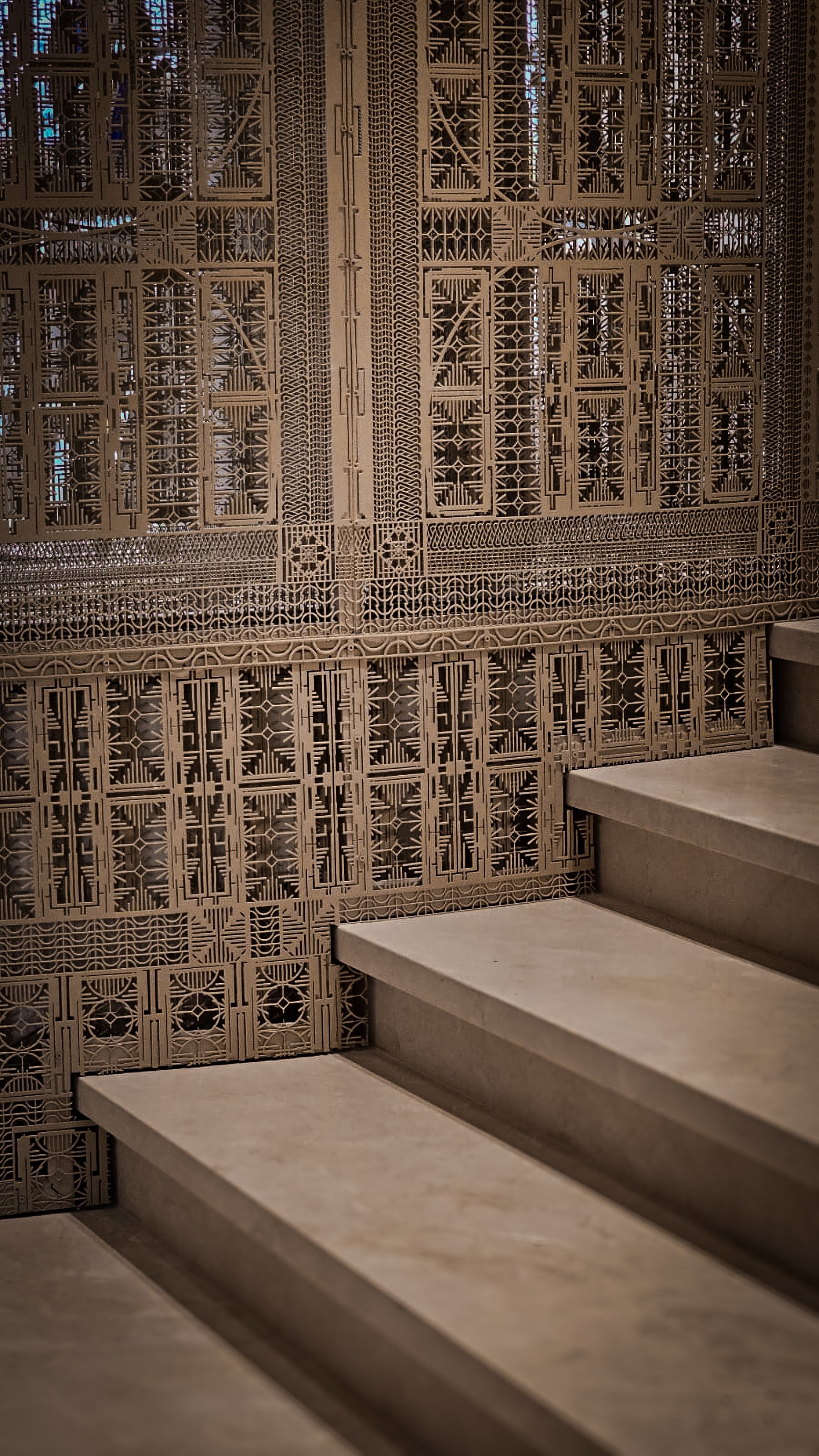 A decorative screen beside a stair